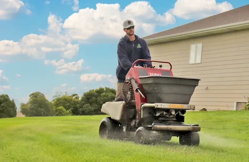 lawn technician working on lawn